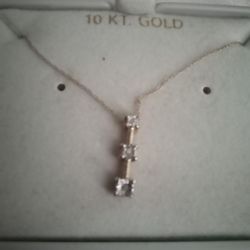 14k gold chain with 10k gold pendant with 3 diamond chips, make offer