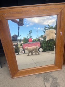 rectangular wooden-framed wall mirror