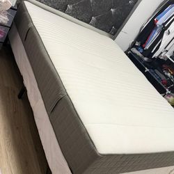 Queen-size mattress and upholstered headboard set.