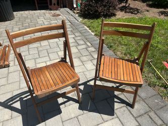 Two wooden foldable chairs.