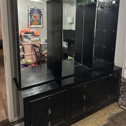 Black Cabinetry With Mirror And Glass Shelves