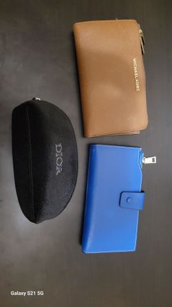 Woman wallet and Dior beauty pouch .