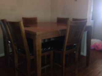 Dining table missing one glass piece and chair needs tightening.