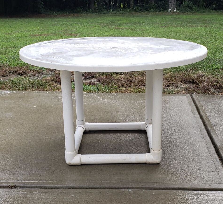 Large white round outdoor patio table, top is very heavy and solid, there is a hole for umbrella if you want, bottom has holes for screw but we never