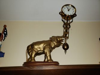 Antique swinging elephant clock in excellent physical and running condition.