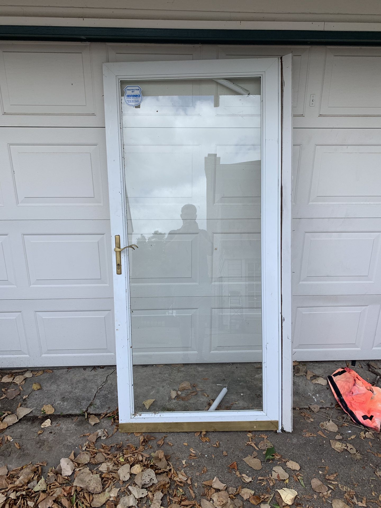 Single glass pane with metal border storm door