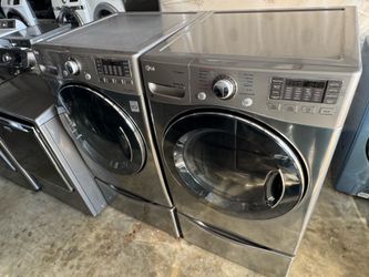 Graphite steel front load lg steam washer and front load lg steam dryer with pedestals  working perfectly with warranty extra for delivery same day de