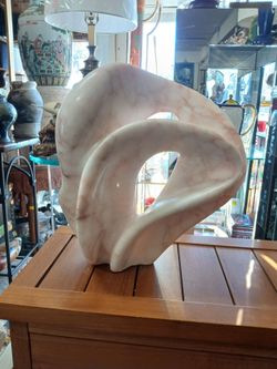 hand-carved, organic abstract sculpture made from pink and white marble sign