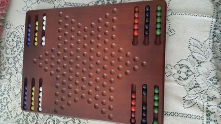 CHINESE CHECKERS with marbles . Board is solid mahogany. A Collector's item.