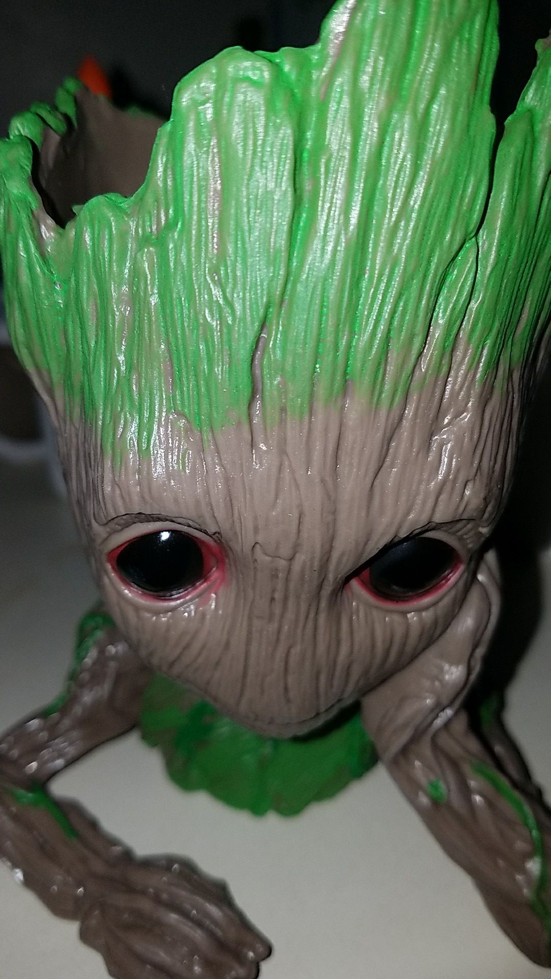 Groot planter with hand on face