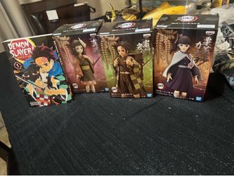 Figures of demon slayer and book