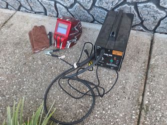 Wire feed welder with helmet and gloves