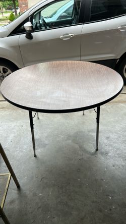 Round table 3 feet 11 inches wide and 2 feet 5 inches tall