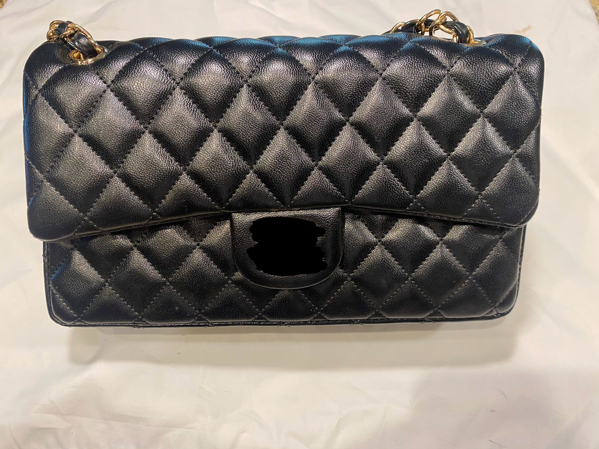 Quilted shoulder purse and gold hardware.