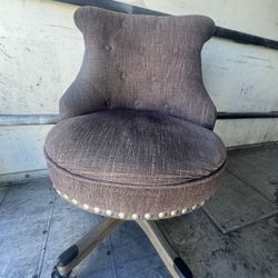 brown upholstered swivel chair