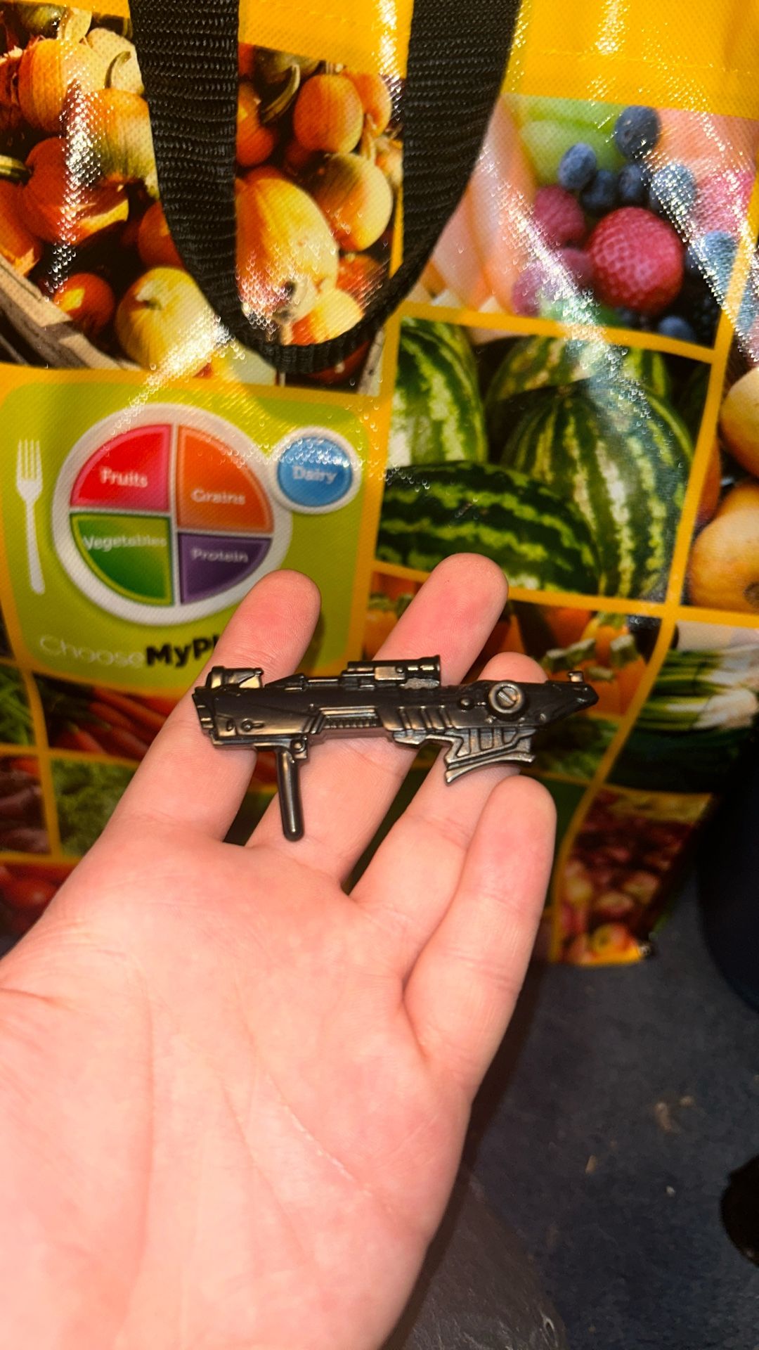 Small black futuristic gun figurine with useable handle