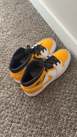 Yellow and white Jordan 1 mid trainers
