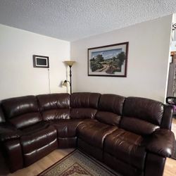 Brown leather couch with two recliners