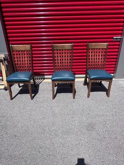 Three teal seated chairs