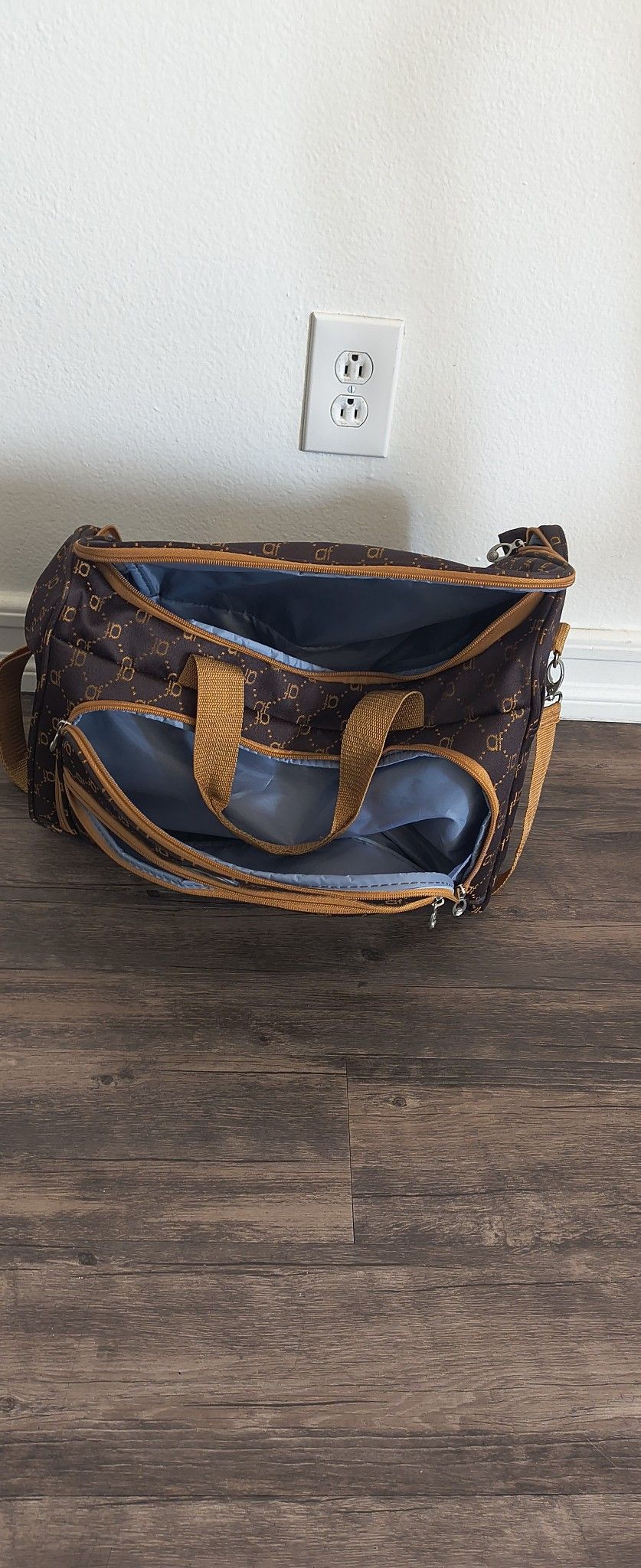 Brown and gold duffel bag