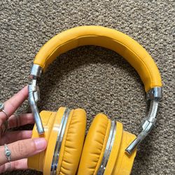 yellow wireless over the ear headphones 