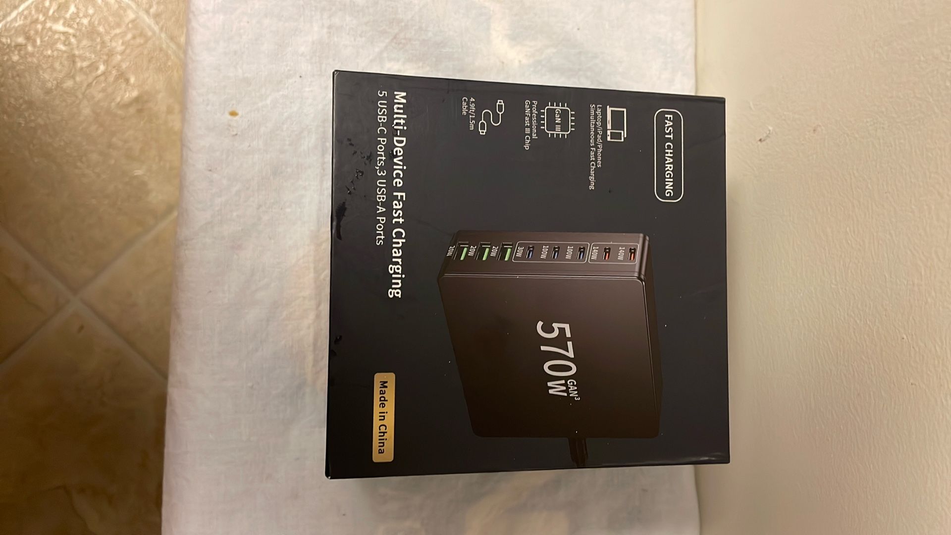   The image shows a 570W multi-device fast charger with 5 USB-C ports and 3 USB-A ports.