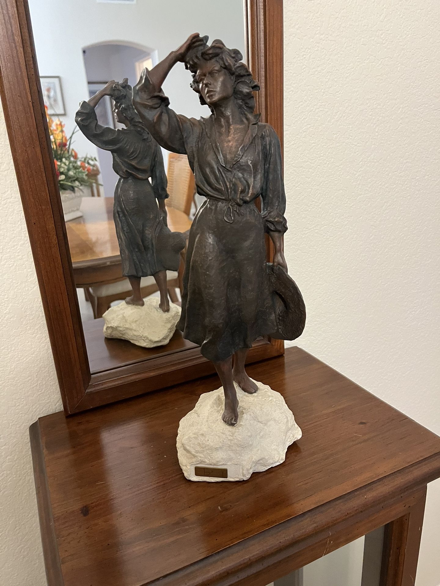 Statue of woman made to look like metal display piece