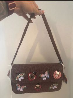 Brown beaded bag with bug detailing