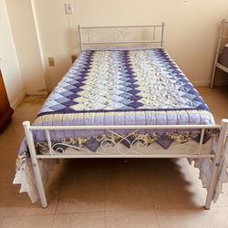 Two white iron twin beds