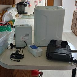 Inogen One 5G  and A Inogen At Home. All Batteries And Accessories And Lots Of Hoses Included