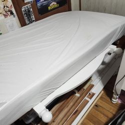 two white wooden twin beds.