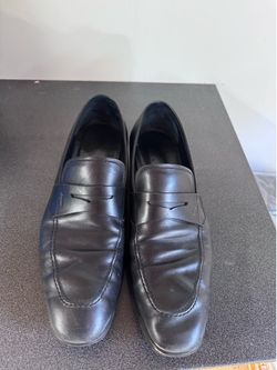 Salvatore Ferragamo black leather penny loafers.