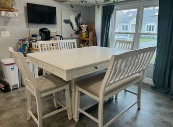 Cardi's furniture counter height dining set - table with four chairs and a bench