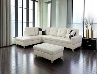 White leather sectional couch and ottoman