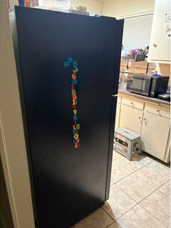 Black fridge with white stove
