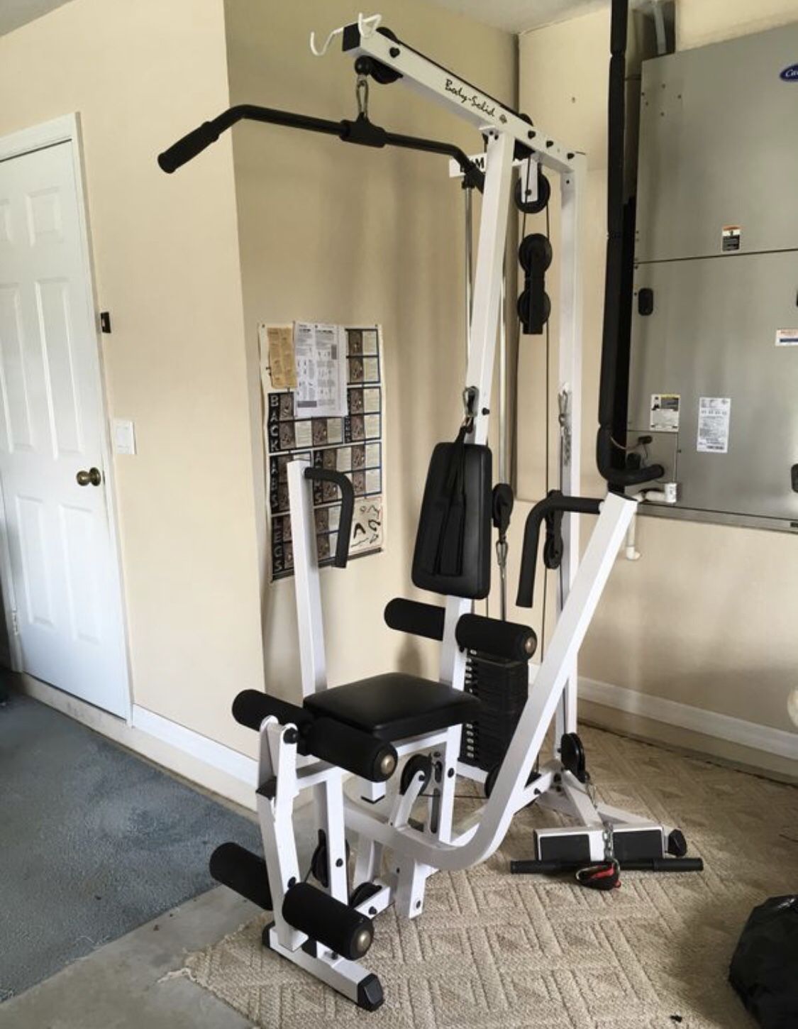 Body Solid home multi gym excellent condition with attachments Sells for $1225 plus taxes includes LARGE RUBBER MAT and tricep rope, rower, lat at