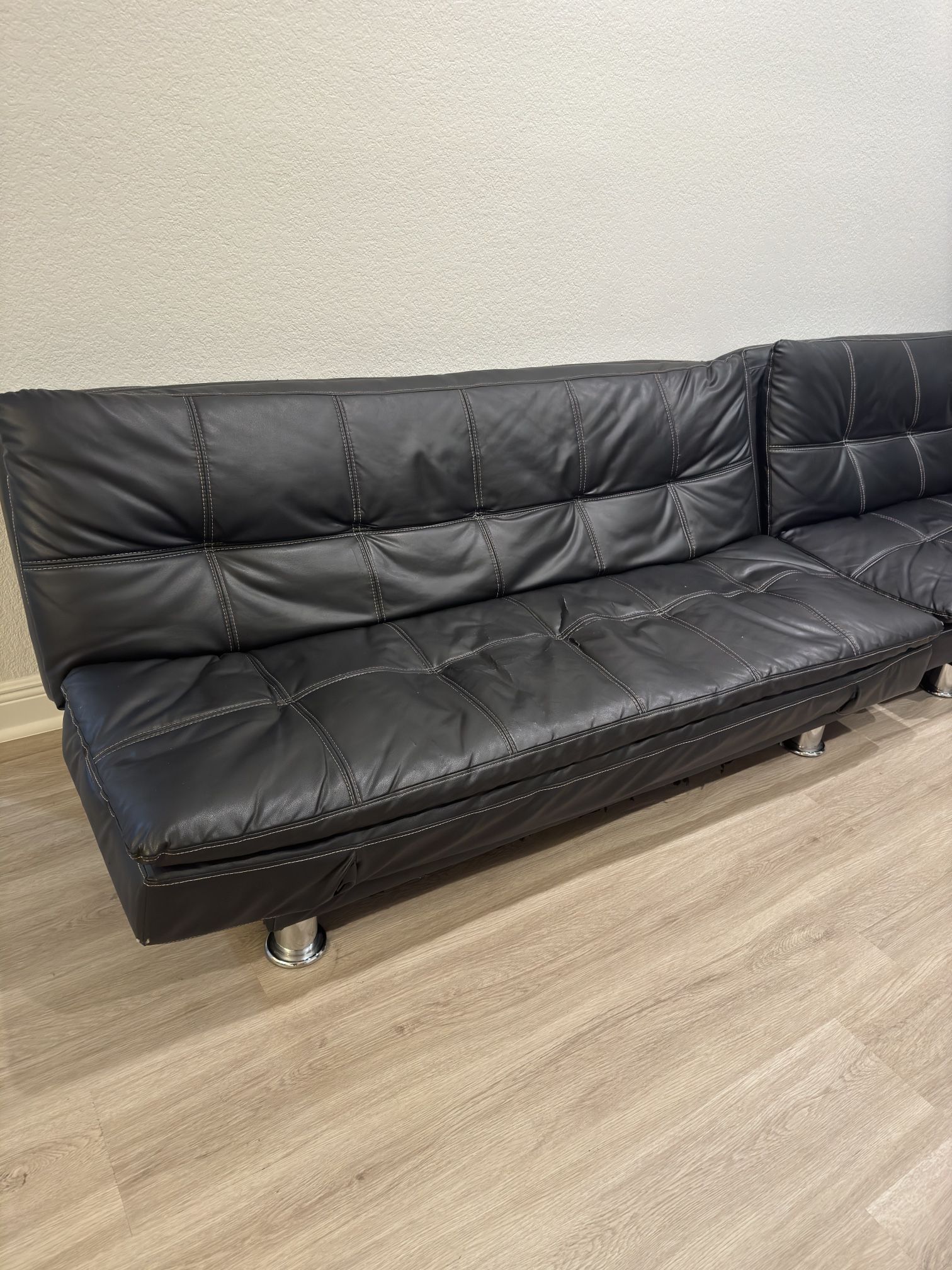 Two black leather Futons
