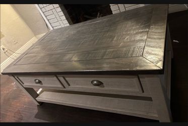 a center coffee table with two chips on 2  corners off the table both for $160