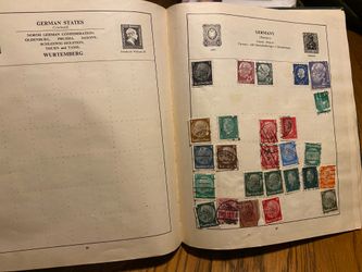 Vintage "The Strand" stamp album containing 428 total stamps.