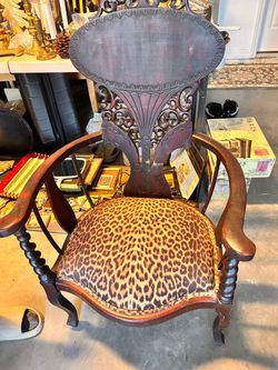 Antique Victorian carved mahogany armchair with leopard print upholstery