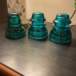 Set of 3 teal glass insulators(2 are #42 and 1 is #40) #40 has one chip at the base, one of the #42 has one chip at the base and the has 2 chips at th
