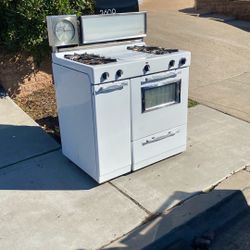 Antique Gas stove 36 inches wide with griddle working free