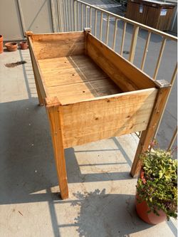 Raised wooden planter box