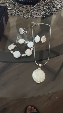 Silver necklace, earring, bracelet, and ring set