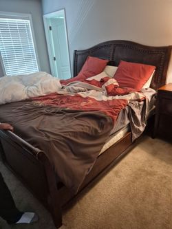 Brown King size wooden bed frame and head board