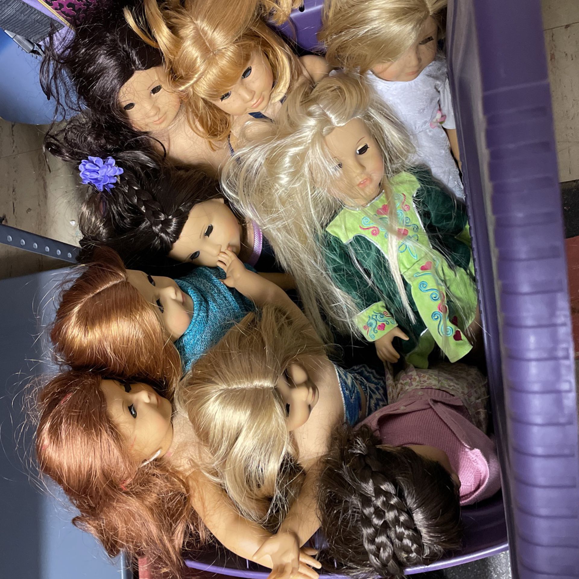 9 American Girl Dolls And A Bin Filled With Clothes Hair Chair And Wheel Chair