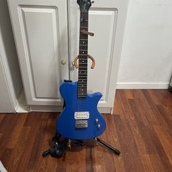 First Act ME5008 electric guitar. This model features a distinct single-cutaway design and a bright blue glossy finish