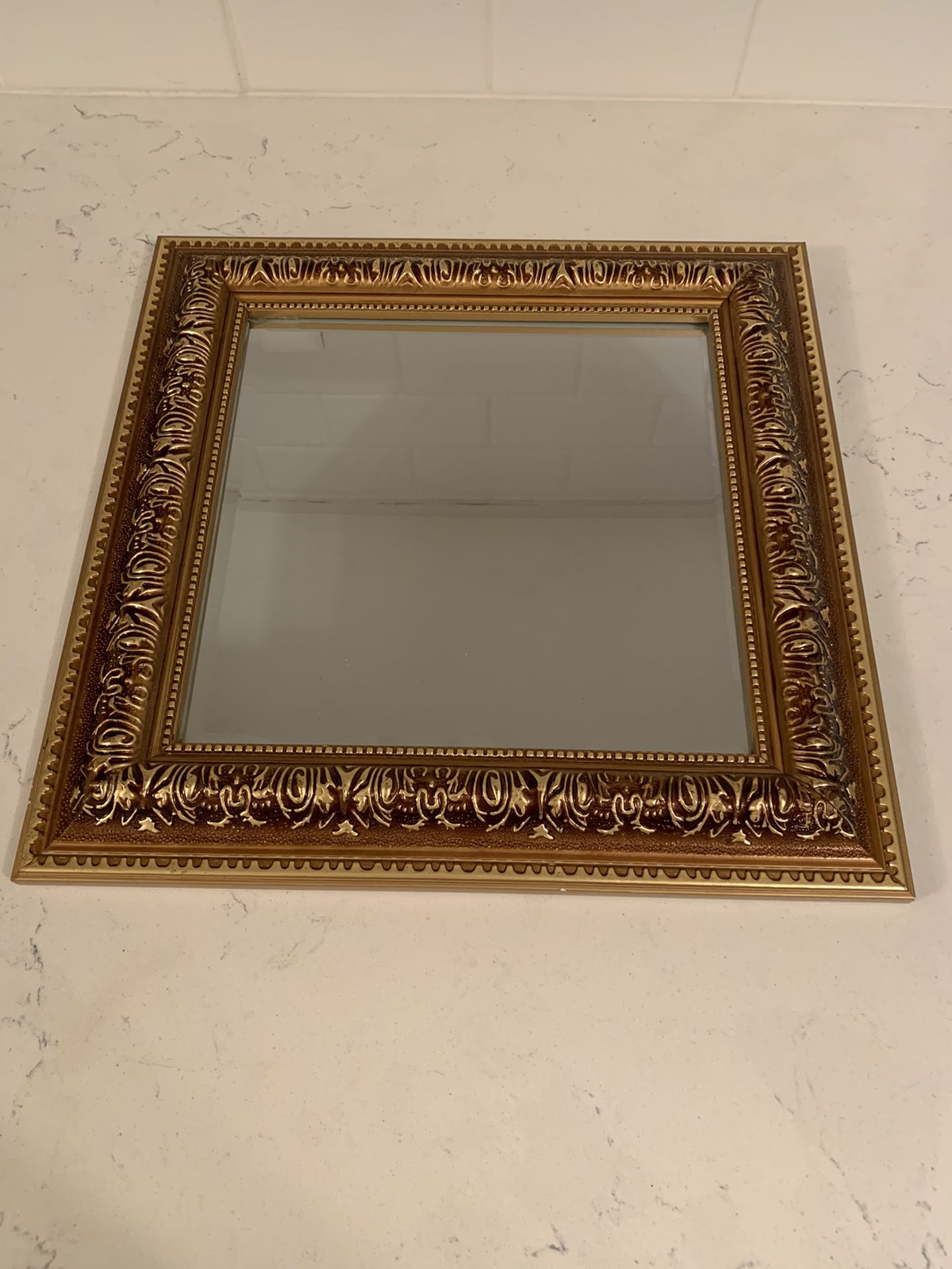Gold tone ornate mirror