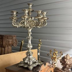 Ornate silver-plated candelabra with floral and acanthus leaf motifs. Candelabra, derived from the Latin word for 'candle,' are branched candlesticks 