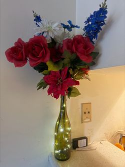 Decorative Flower Arrangement in Glass Bottle Vase with string lights